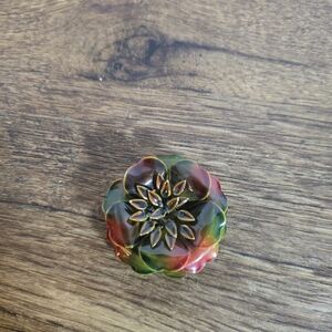 flower-shaped brooch or pin.